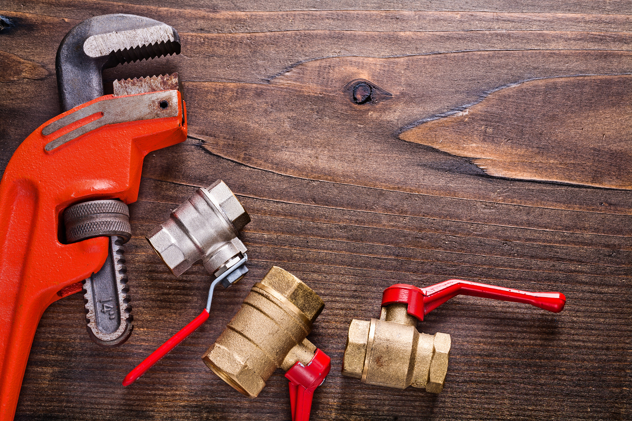 Plumbing Tools and Wood Background